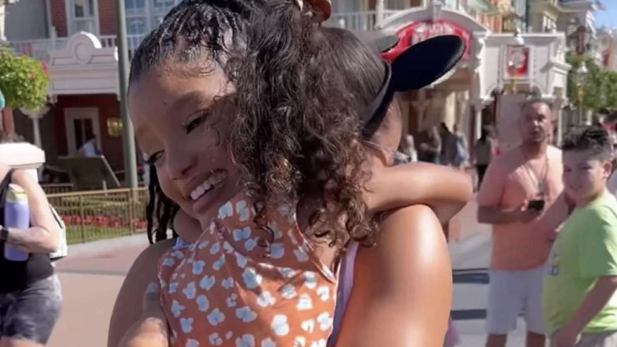A young fan of "The Little Mermaid" clings to actress Halle Bailey when she saw her at Disney World in Florida.