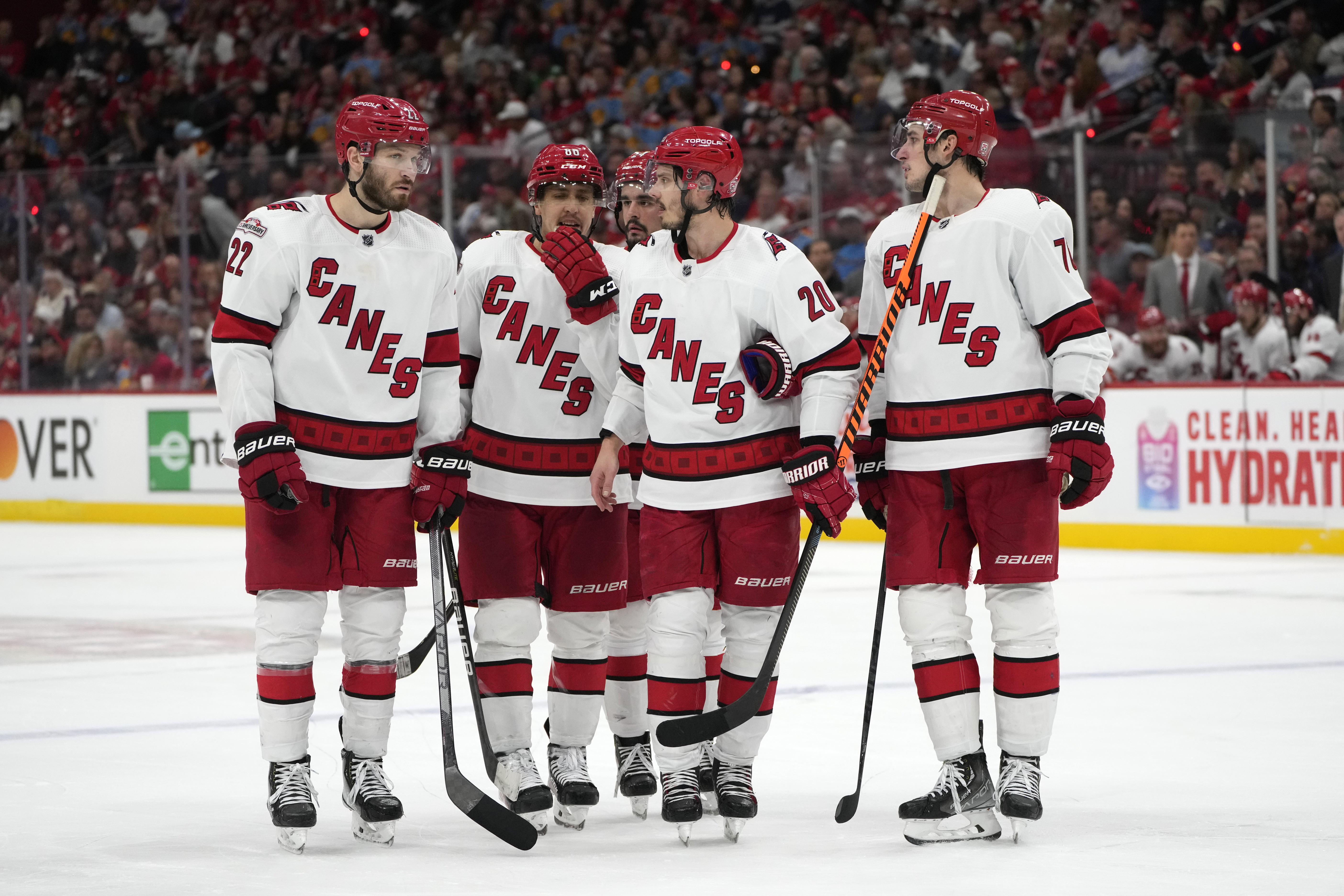 Carolina Hurricanes players talk during a break in the third period of Game 4 of the NHL hockey Stanley Cup Eastern Conference finals against the Florida Panthers, Wednesday, May 24, 2023, in Sunrise, Fla.