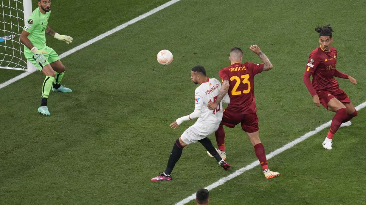 Roma's Gianluca Mancini, number 23, scores an own goal during the Europa League final soccer match between Sevilla and Roma, at the Puskas Arena in Budapest, Hungary, Wednesday, May 31, 2023.