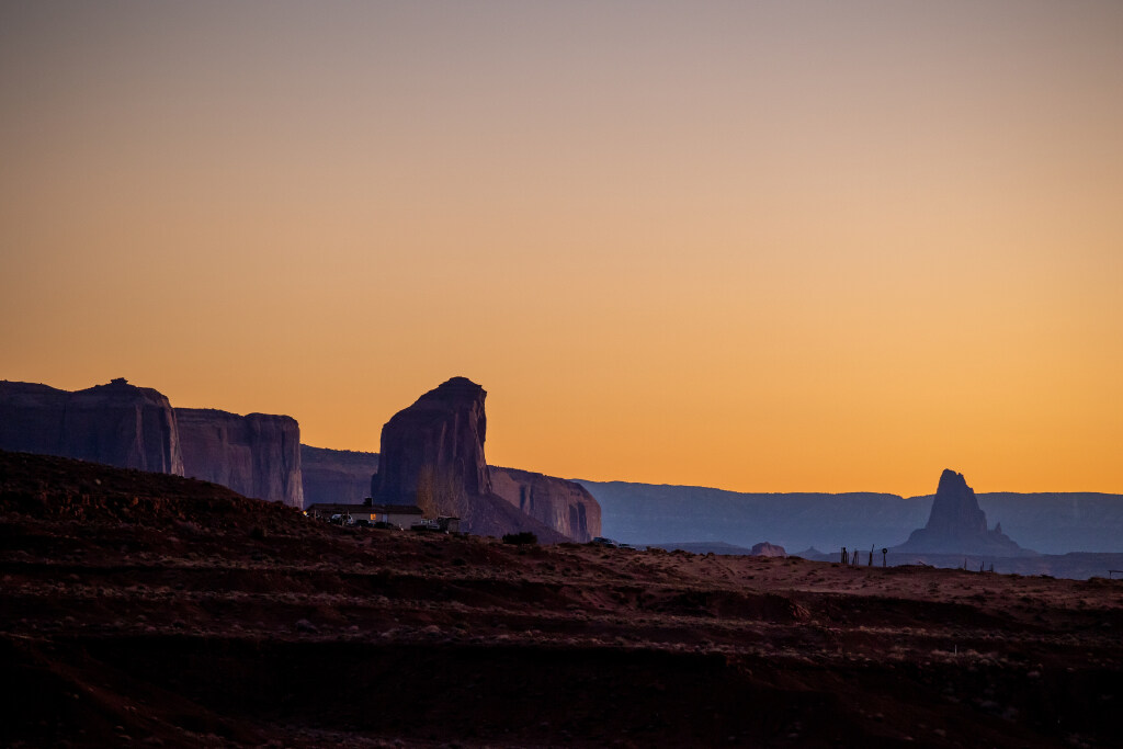 Homes on the Navajo Nation near Monument Valley in Utah are pictured at dusk on Nov. 15, 2022. Federal money is coming to help clean up uranium mine tailings in the area.