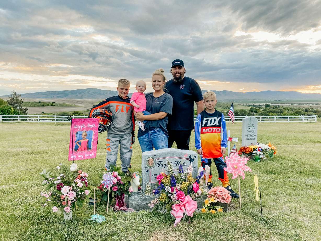 The Hale family stands in front of Tayzli Hale's grave in Logan.