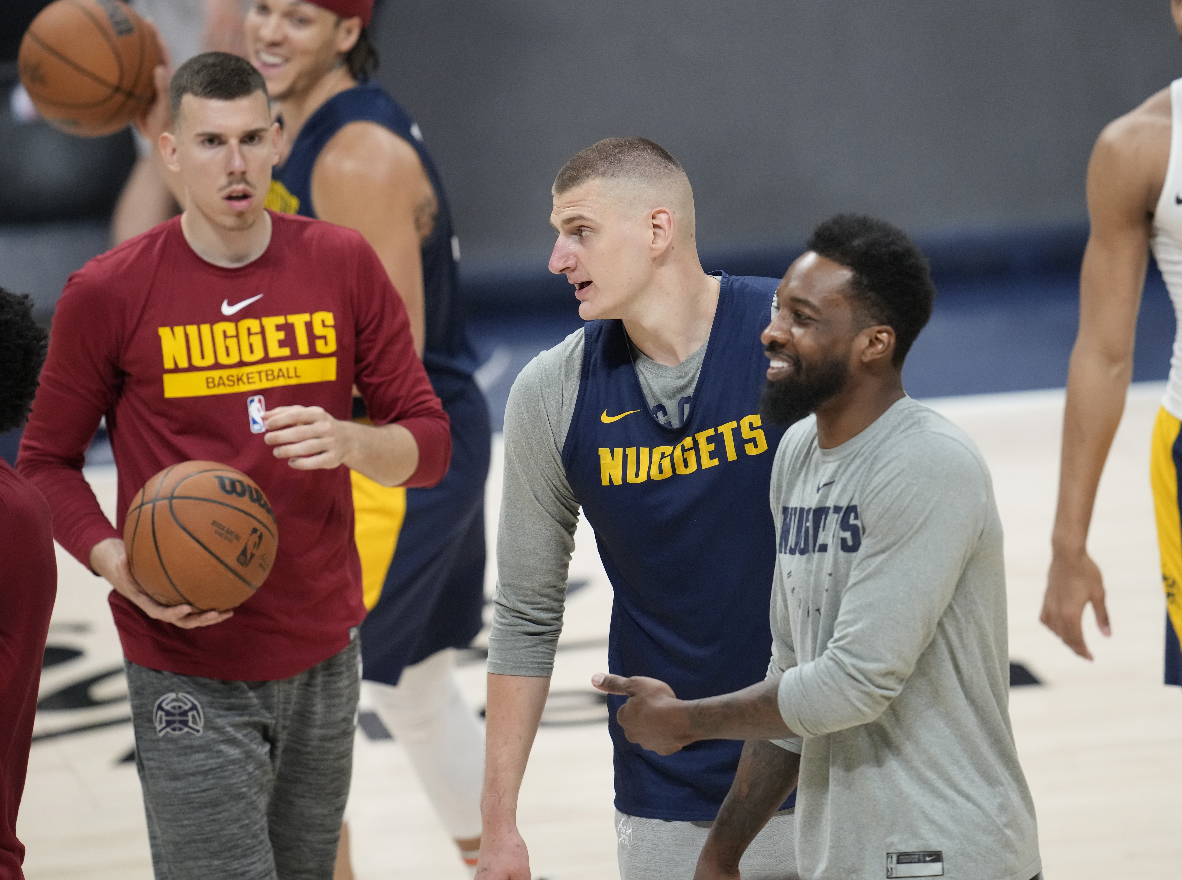 Denver Nuggets center Nikola Jokic, center, jokes around with forwards Vlatko Cancar, left, and Jeff Green during practice ahead of Game 1 of the NBA basketball finals against the Miami Heat Wednesday, May 31, 2023, in Denver.