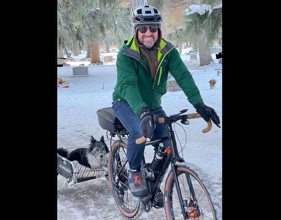 Xavier Desforges riding on a bike with Remi in the back, as seen in an undated photo.