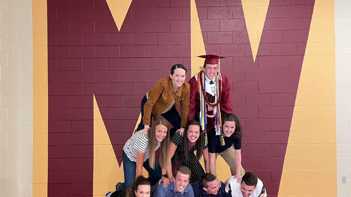 The Bates siblings gather for a photo after the youngest of 11 graduated May 25 from Mountain View High School in Orem.