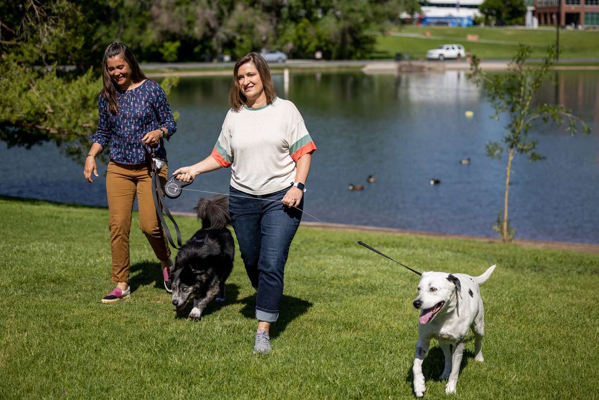 Salt Lake City Mayor Erin Mendenhall, left, and her dog Jack, and Salt Lake County Mayor Jenny Wilson and her dog Puddles, came together for a press conference on water safety at Sugar House Park in Salt Lake City on Thursday. Officials are warning people and their pets to stay clear of rivers and creeks swollen by spring snowmelt.