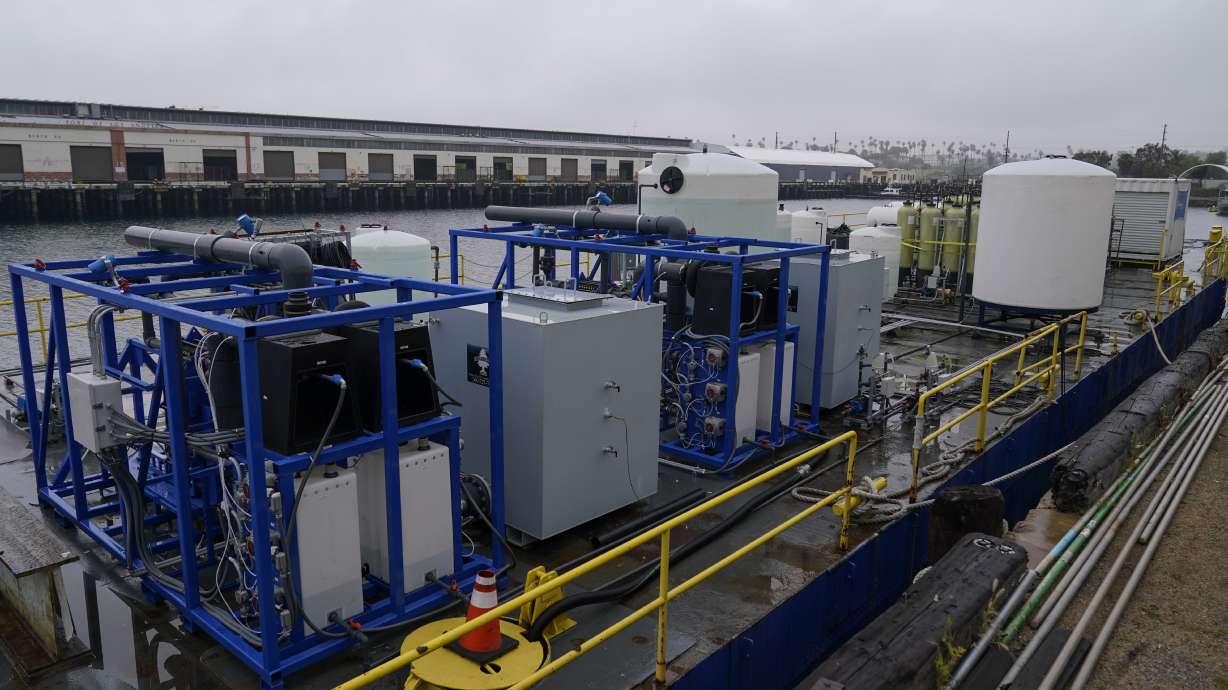 A demonstration site of a seawater-based carbon removal system is set up on a barge, Wednesday, April 12, 2023, in San Pedro, Calif. Equatic, a Los Angeles startup that is designing facilities to remove carbon dioxide from the ocean says it has struck an agreement with Boeing to provide the aerospace giant with a byproduct of the process to help it cut emissions from planes.