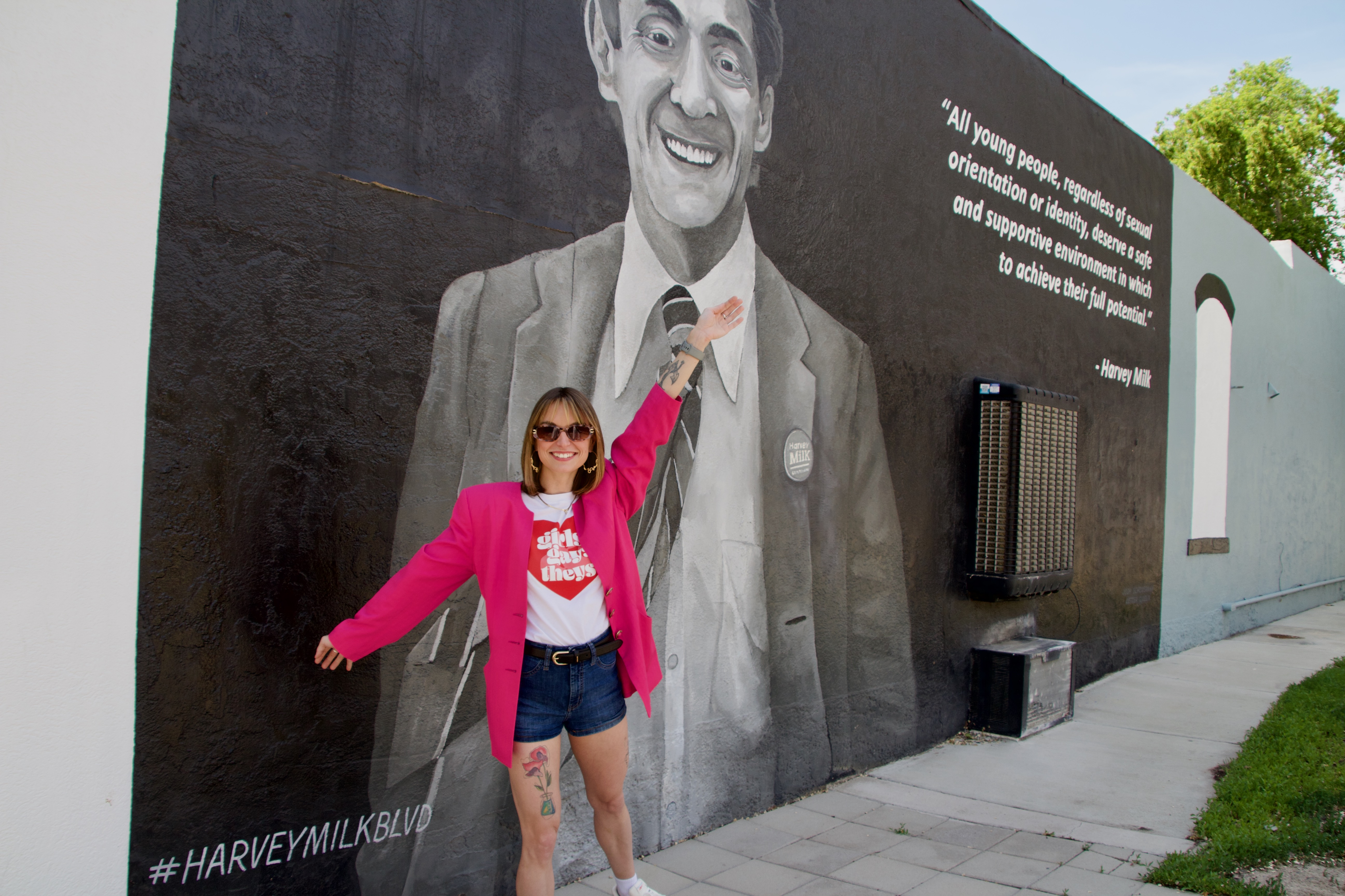 Kristen Wolfe, owner and creative director of Vintage Drift SLC, poses for a photo in front of the Harvey Milk mural outside her shop in downtown Salt Lake City on May 18. Milk was a human rights leader and one of the first openly gay elected officials in the country.