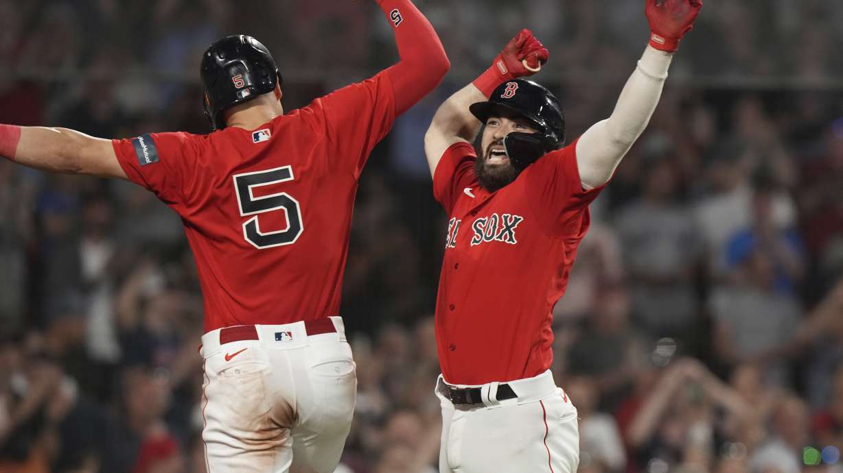Boston Red Sox's Connor Wong, right, celebrates with Enrique Hernandez (5) after hitting a two-run home run against the Cincinnati Reds during the eighth inning of a baseball game Thursday, June 1, 2023, in Boston.