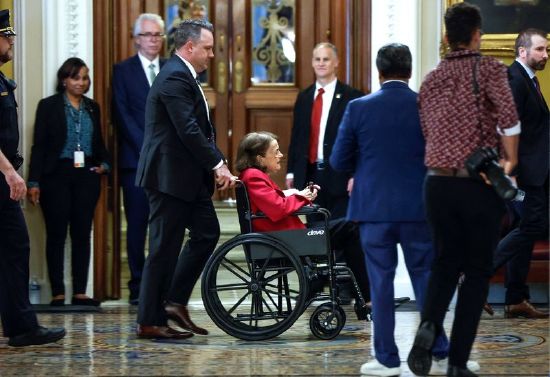 U.S. Senator Diane Feinstein, D-Calif., is wheeled past the Senate floor as lawmakers wrangle over the vote on debt ceiling legislation to avoid a historic default at the U.S. Capitol in Washington, Thursday.