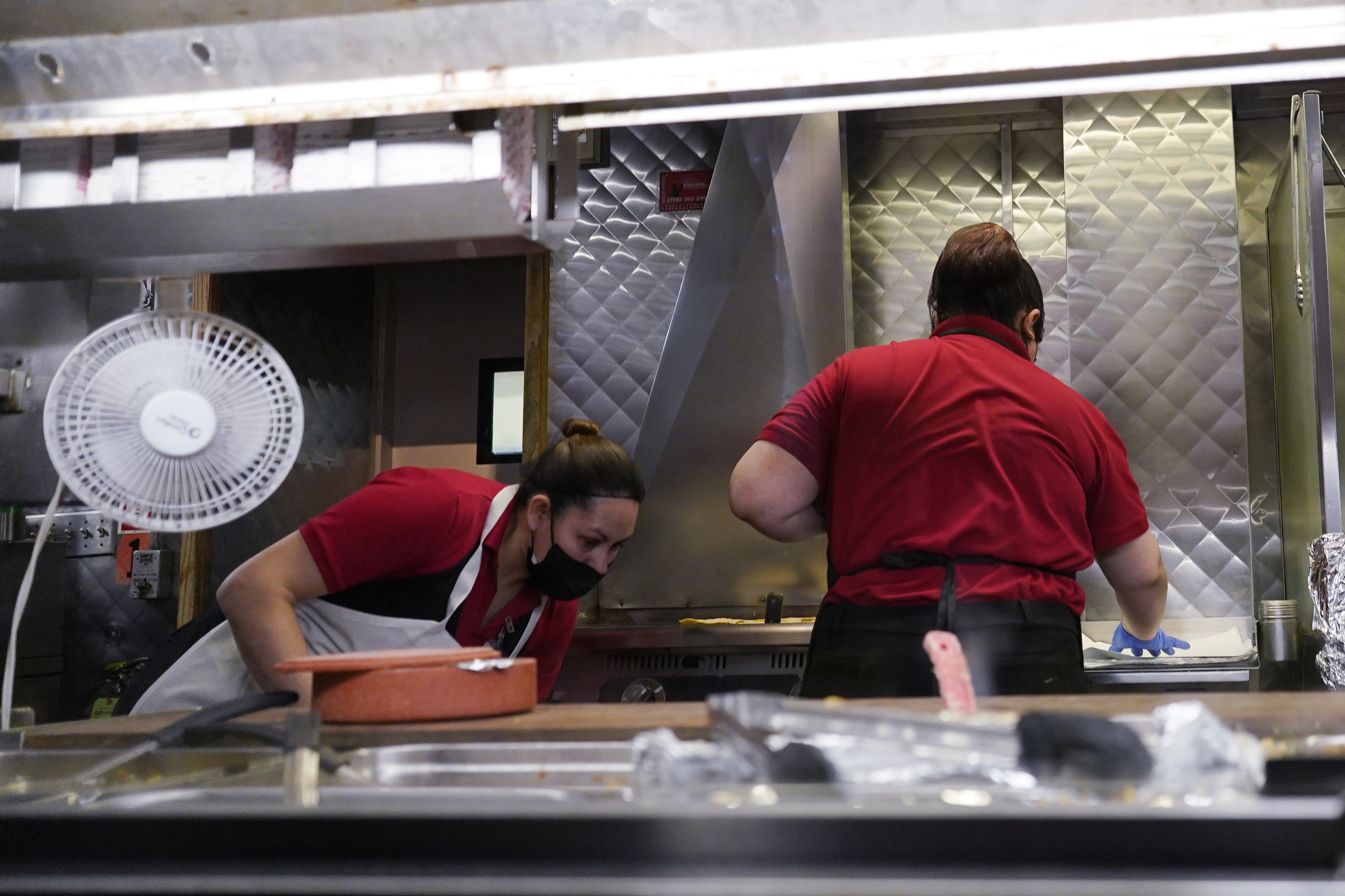 Women work in a restaurant kitchen in Chicago, March 23. The nation's employers added a robust 339,000 jobs in May, the Labor Department reported Friday.