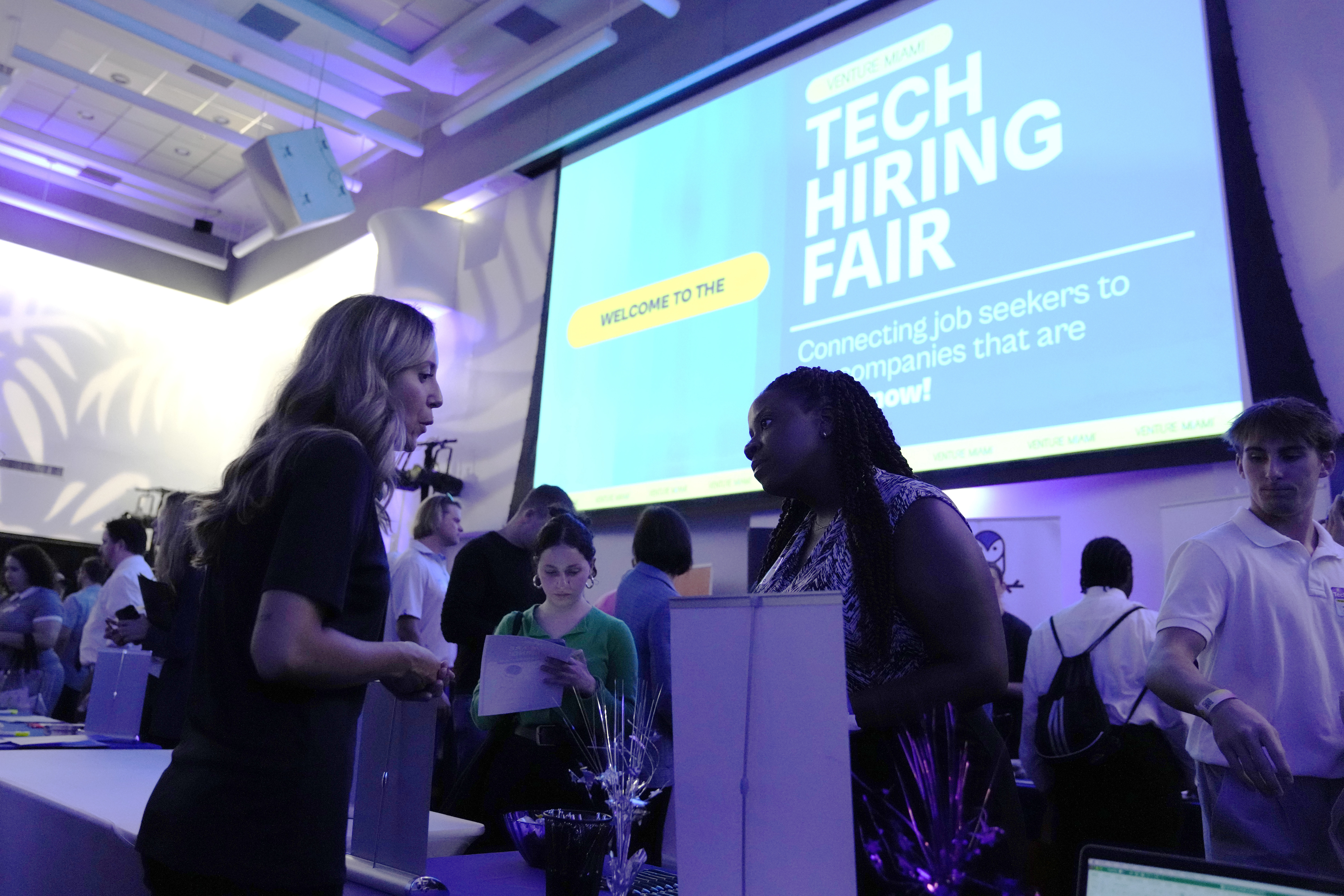 Visitors attend the Venture Miami Tech Hiring Fair at the Miami-Dade College, Wolfson campus, April 26, in Miami. On Friday, the U.S. government issued the May jobs report.
