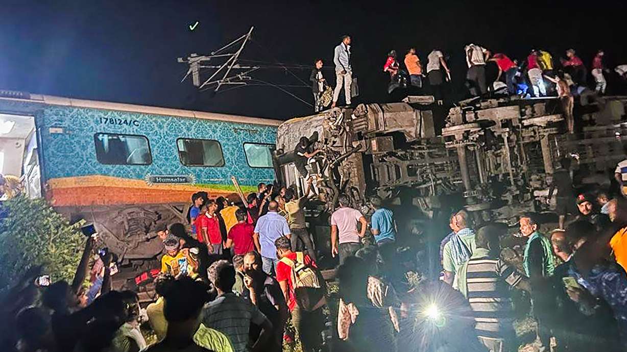 Two passenger trains derailed Friday in India, killing more than 200 people and trapping hundreds of others inside more than a dozen damaged rail cars, officials said.