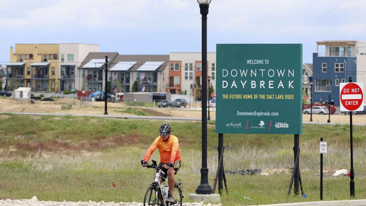 A cyclist bikes past the site of the future Salt Lake Bees ballpark in South Jordan on Friday.
