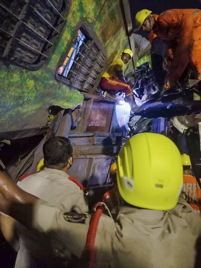 Rescuers work at the site of passenger trains that derailed in Balasore district, in the eastern Indian state of Orissa, Friday.