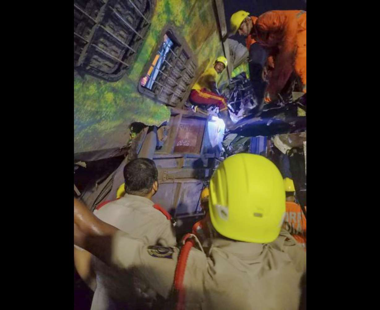 Rescuers work at the site of passenger trains that derailed in Balasore district, in the eastern Indian state of Orissa, Friday.