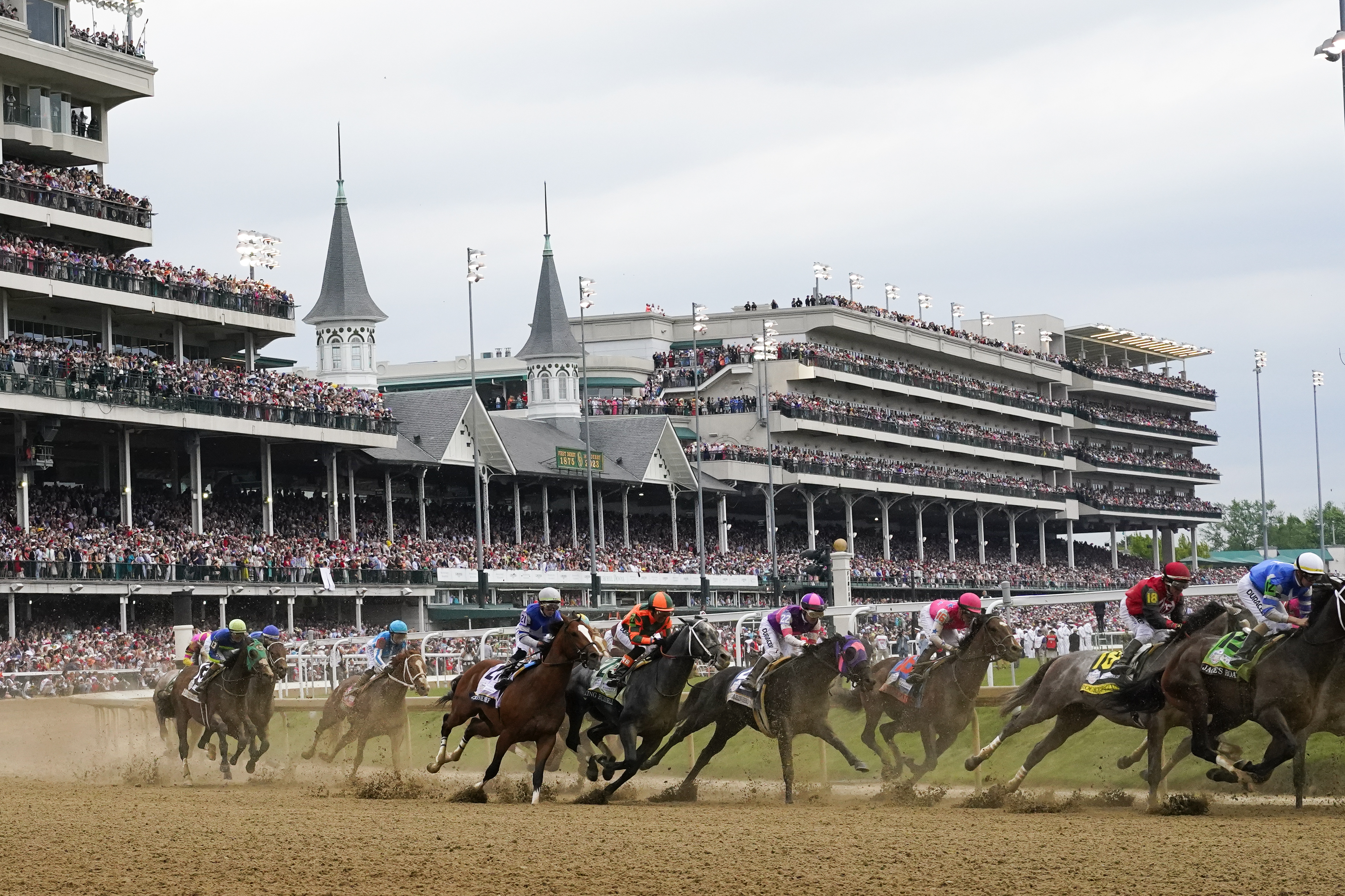 FILE - Javier Castellano, atop Mage, third from left, is seen behind with others behind the pack as they make the first turn while competing in the 149th running of the Kentucky Derby horse race at Churchill Downs Saturday, May 6, 2023, in Louisville, Ky. Churchill Downs will limit horses to four starts during a rolling eight-week period and impose ineligibility standards for continued poor performance in the wake of the recent deaths of 12 horses at the home of the Kentucky Derby.