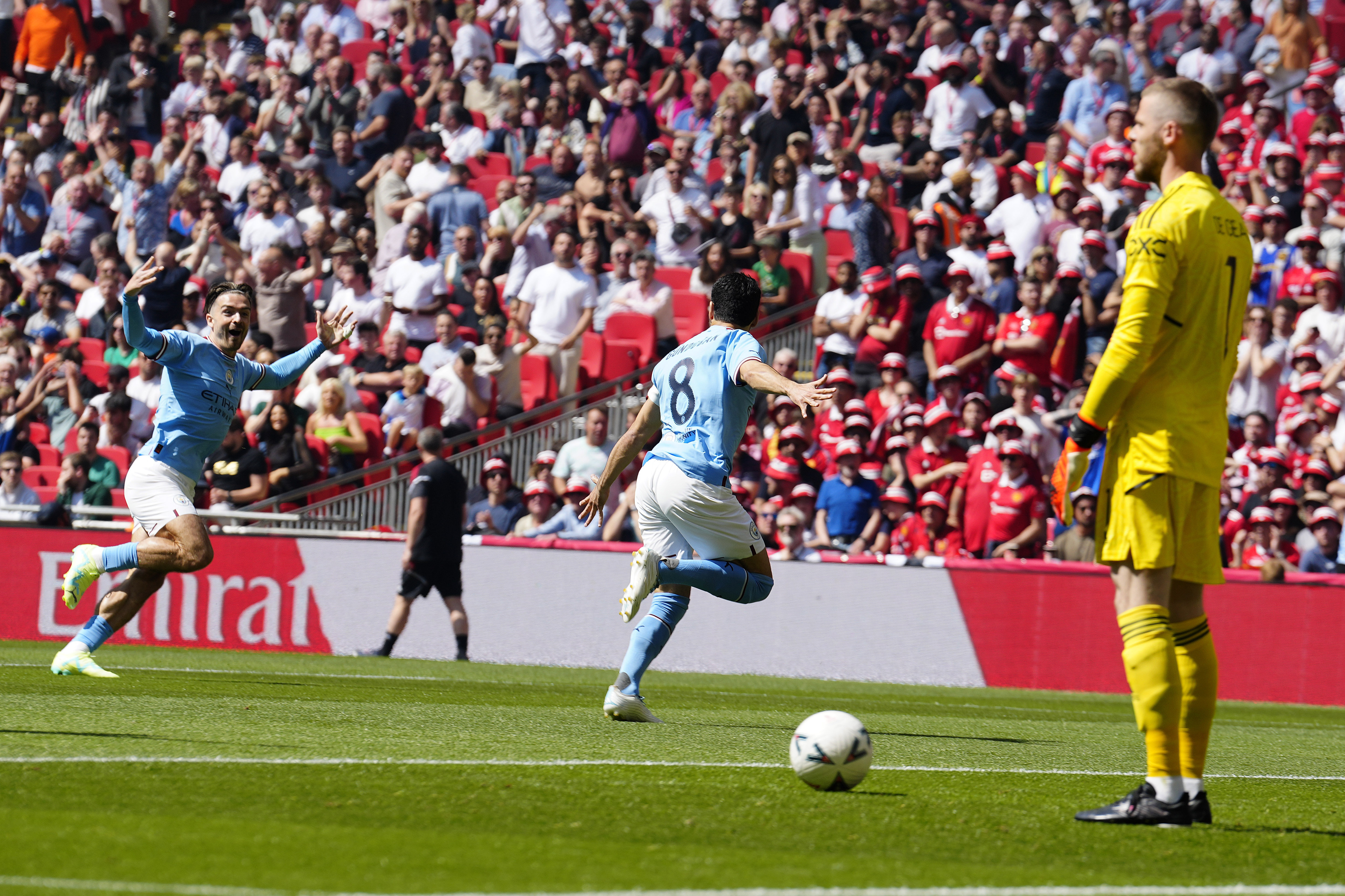 Manchester City's Ilkay Gundogan, centre, celebrates after scoring his side's first goal during the English FA Cup final soccer match between Manchester City and Manchester United at Wembley Stadium in London, Saturday, June 3, 2023.