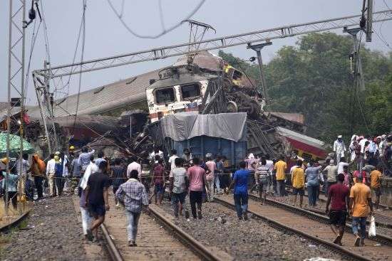Rescuers work at the site of passenger trains that derailed in Balasore district, in the eastern Indian state of Orissa, Saturday. Rescuers are wading through piles of debris and wreckage to pull out bodies and free people after two passenger trains derailed in India, killing more than 280 people and injuring hundreds as rail cars were flipped over and mangled in one of the country’s deadliest train crashes in decades.