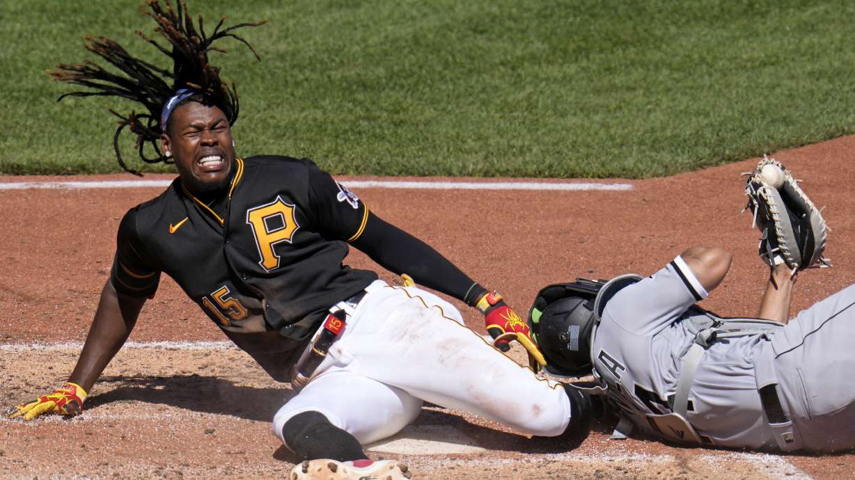 FILE - Pittsburgh Pirates' Oneil Cruz (15) is injured as he is tagged out attempting to score by Chicago White Sox catcher Seby Zavala during the sixth inning of a baseball game in Pittsburgh, Sunday, April 9, 2023. Cruz said Saturday, June 3, 2023, he remains on track to return this season after fracturing his left ankle during an awkward slide into home plate in early April.