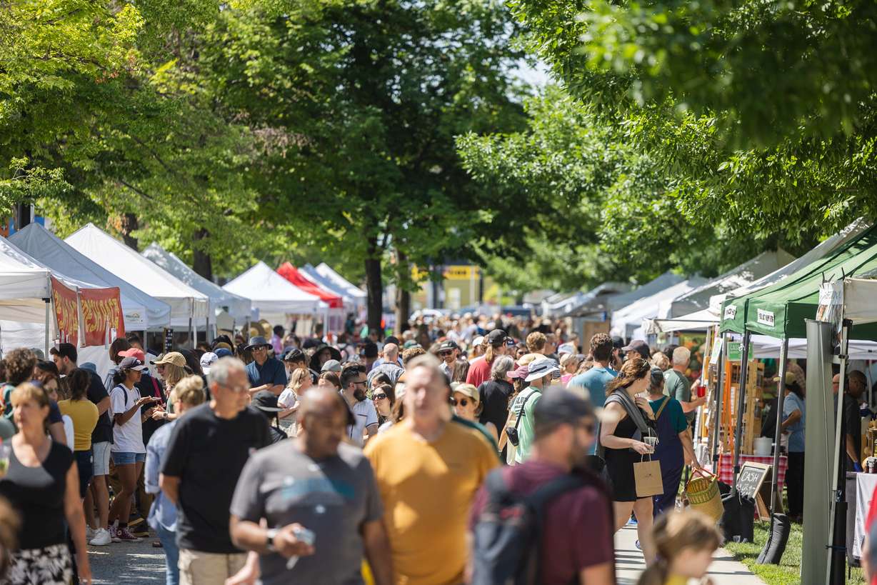 Visitors walk during the reopening of the Salt Lake City Downtown Farmers Market at Pioneer Park in Salt Lake City on Saturday.