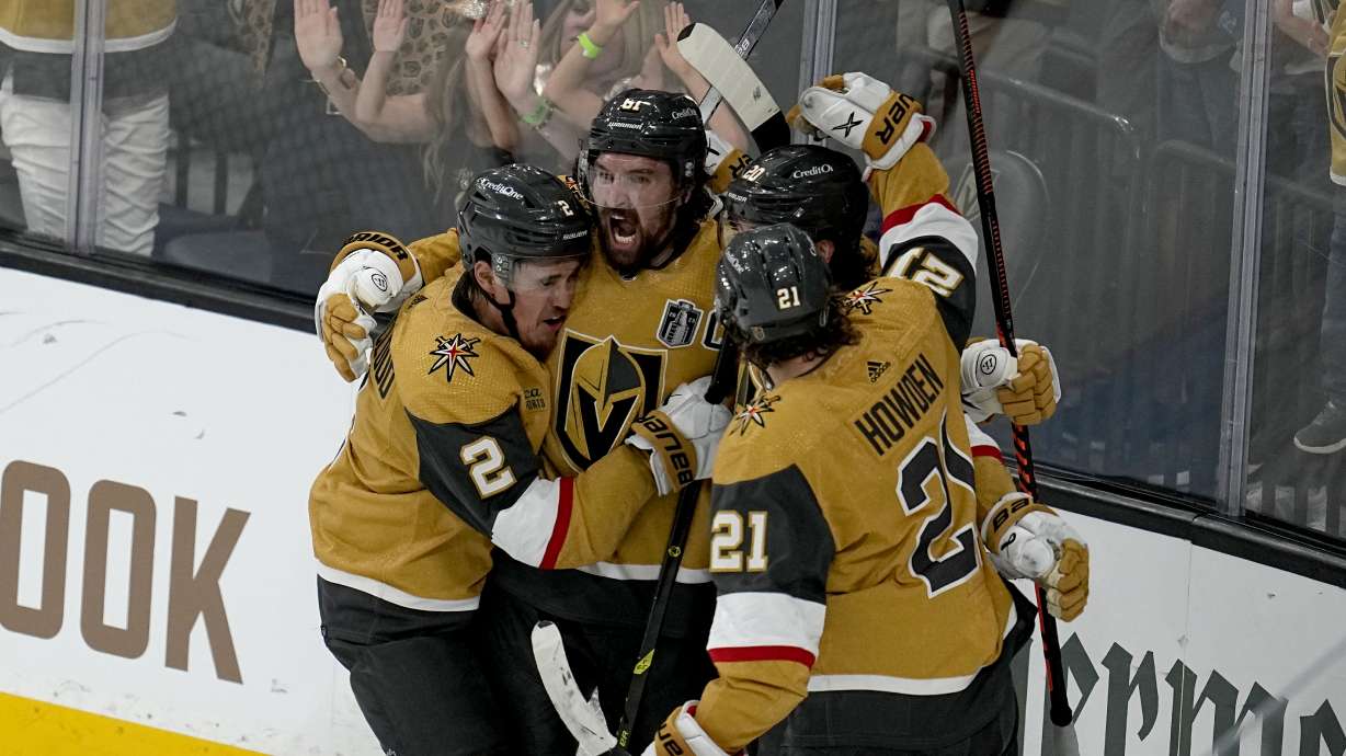 Vegas Golden Knights right wing Mark Stone, left, celebrates his goal against the Florida Panthers with Brett Howden (21), defenseman Zach Whitecloud (2) and center Chandler Stephenson during the third period of Game 1 of the NHL hockey Stanley Cup Finals, Saturday, June 3, 2023, in Las Vegas.