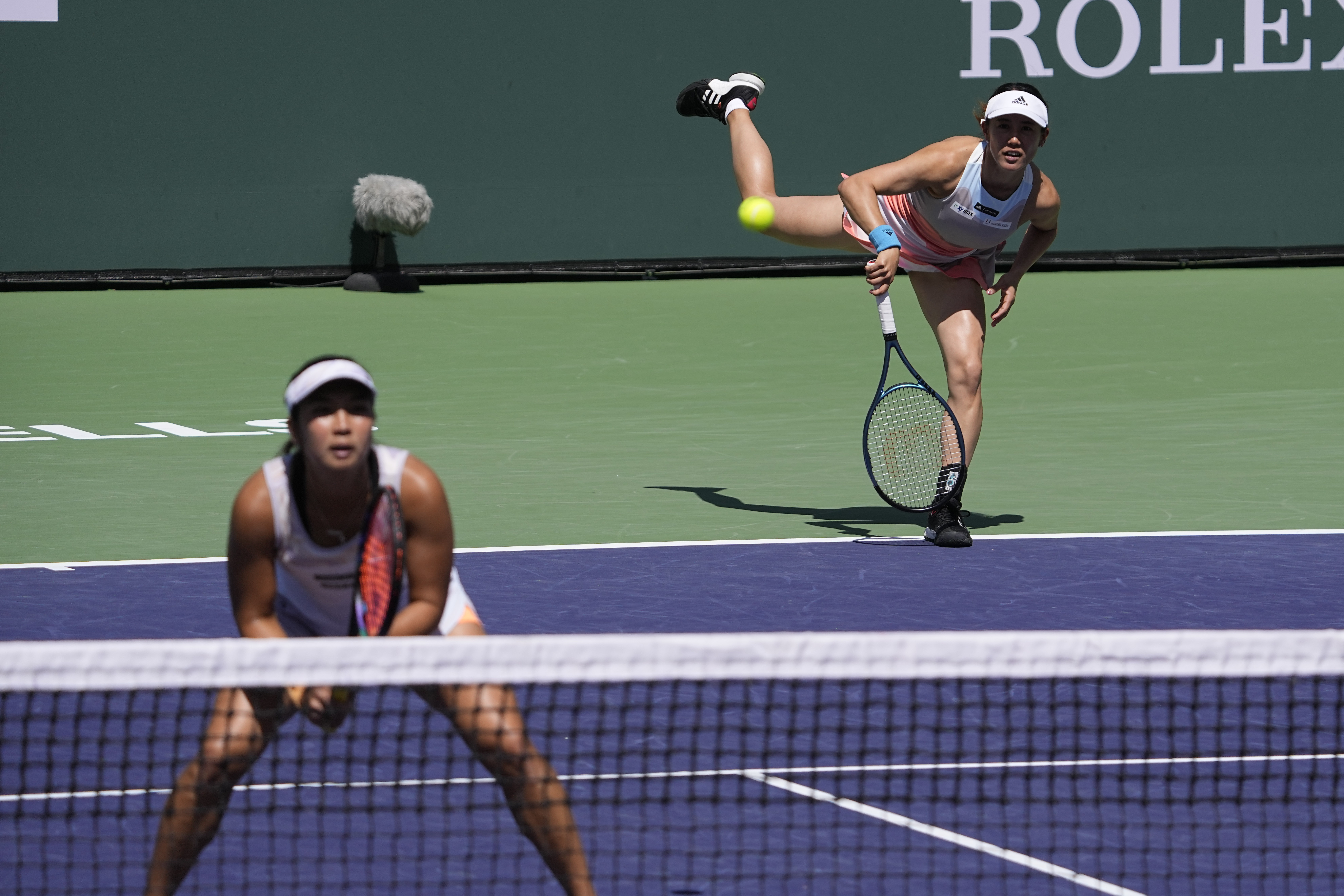 FILE - Miyu Kato, of Japan, right, serves behind her partner Aldila Sutjiadi, of Indonesia, as they play against Beatriz Haddad Maia, of Brazil, and Laura Siegemund, of Germany, in a doubles semifinal match at the BNP Paribas Open tennis tournament Friday, March 17, 2023, in Indian Wells, Calif. French Open doubles player Miyu Kato and her partner Aldila Sutjiadi have been forced to forfeit a match when Kato accidentally hit a ball girl in the neck with a ball after a point during their match against Marie Bouzkova and Sara Sorribes Tormo on Sunday, June 4, 2023. 