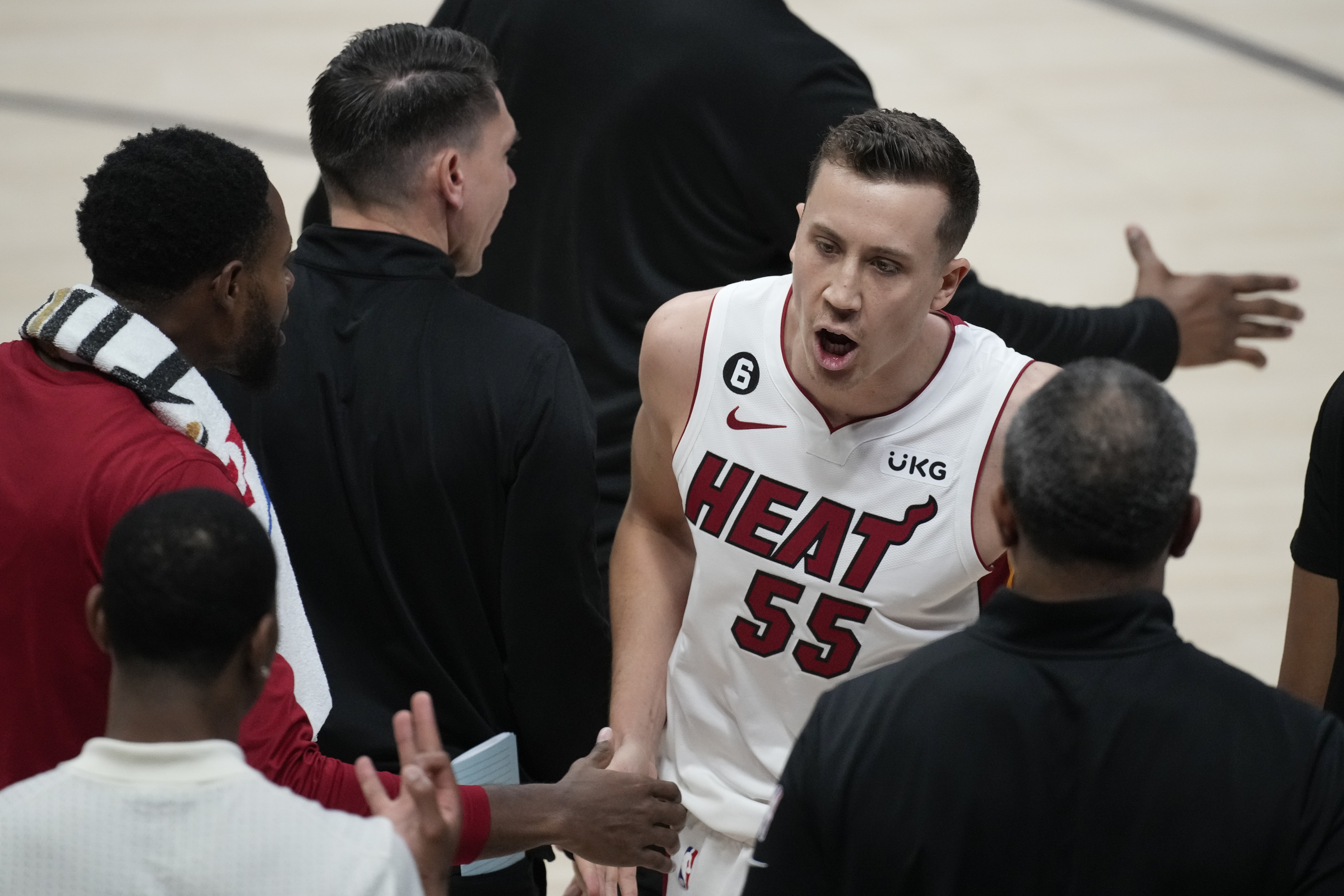 Miami Heat forward Duncan Robinson (55) reacts as he walks to the bench during the second half of Game 2 of basketball's NBA Finals against the Denver Nuggets, Sunday, June 4, 2023, in Denver.