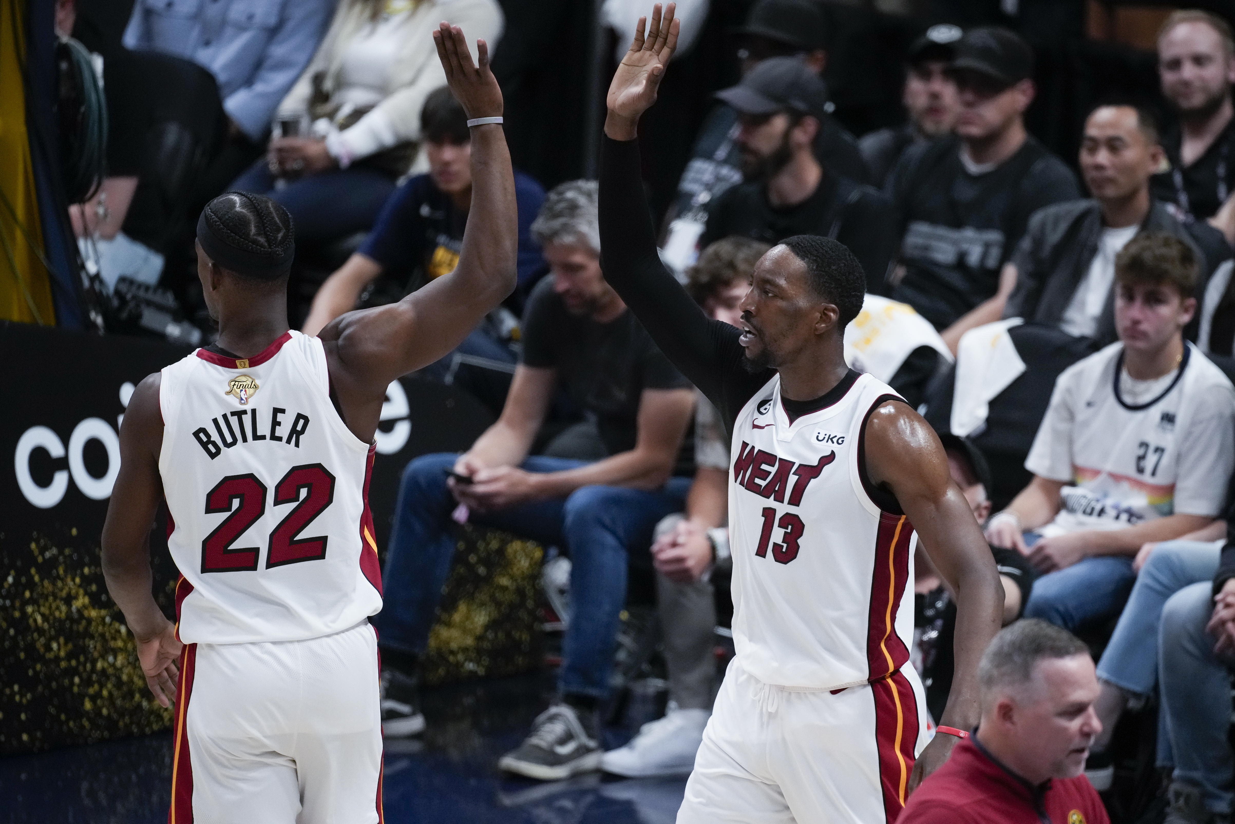 Miami Heat center Bam Adebayo, right, celebrates with forward Jimmy Butler after scoring against the Denver Nuggets during the second half of Game 2 of basketball's NBA Finals, Sunday, June 4, 2023, in Denver.