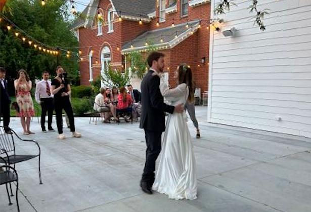 Tyler and Kelsey Poll West dance on their wedding day. Shortly before the two were married, they learned that Tyler's mother delivered his new bride 22 years prior.