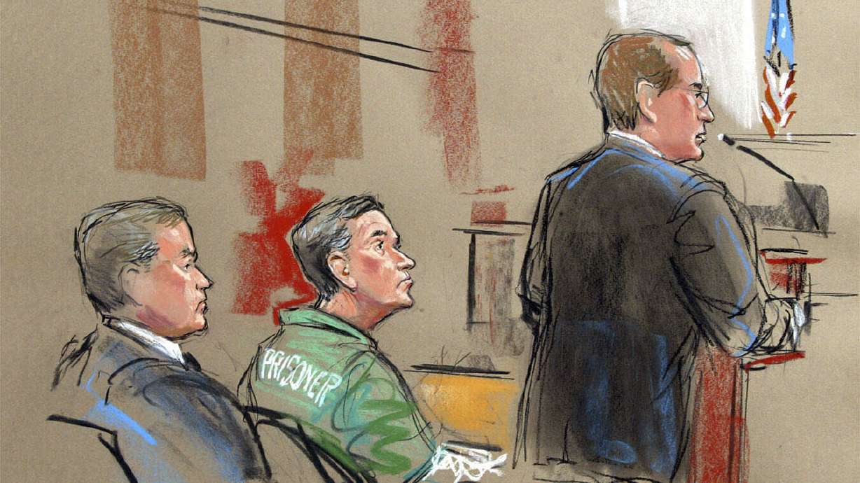 In this artist depiction, U.S. Attorney Randy Bellows, right, addresses the court during the sentencing of convicted spy Robert Hanssen, center, in Alexandria, Va., May 10, 2002. Hanssen has died in prison.