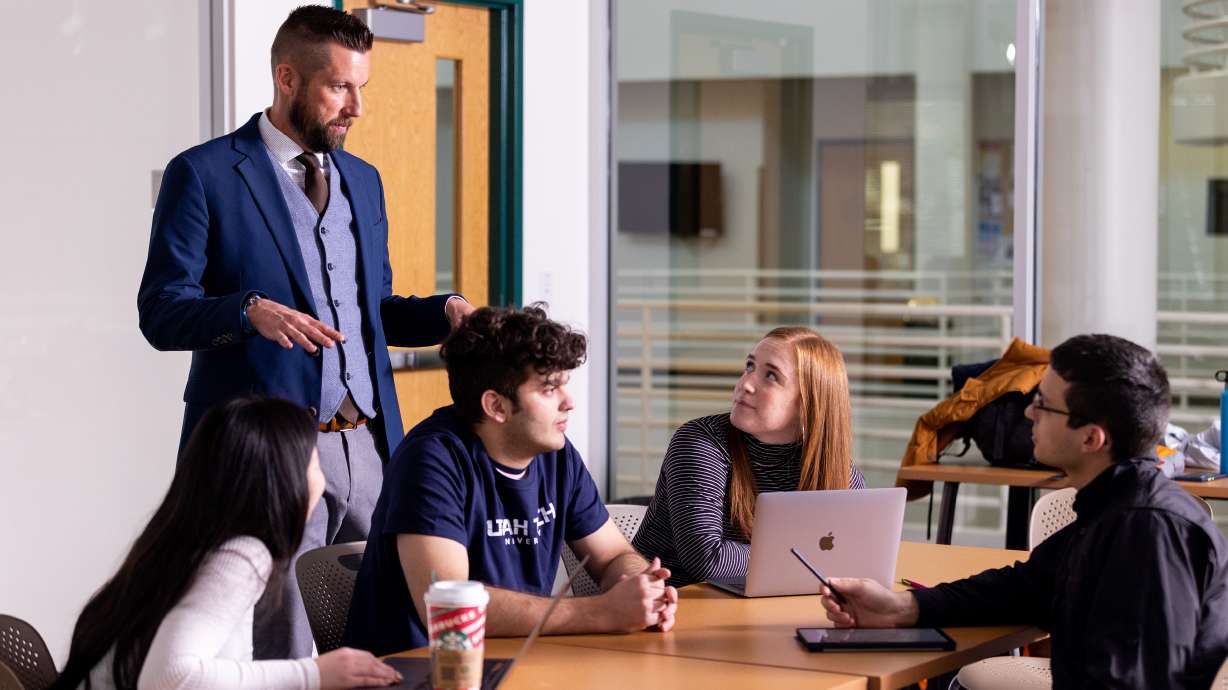 A Utah Tech University professor helps a group of students. Utah Tech is one of 76 institutions included in the First Scholars Network for the 2023-24 school year.
