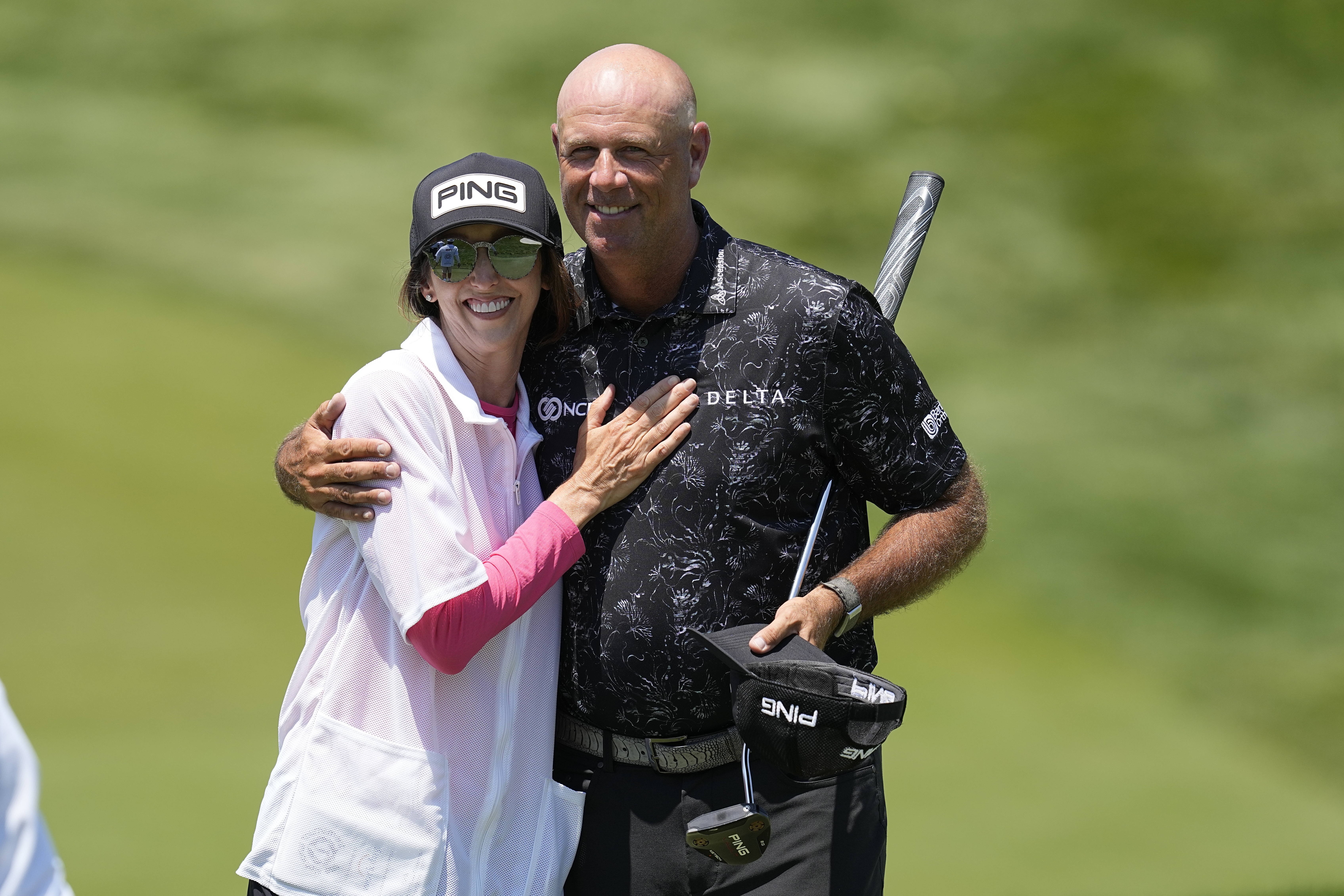 Stewart Cink hugs his wife and caddie, Lisa, after the first round of the Memorial golf tournament, Thursday, June 1, 2023, in Dublin, Ohio.