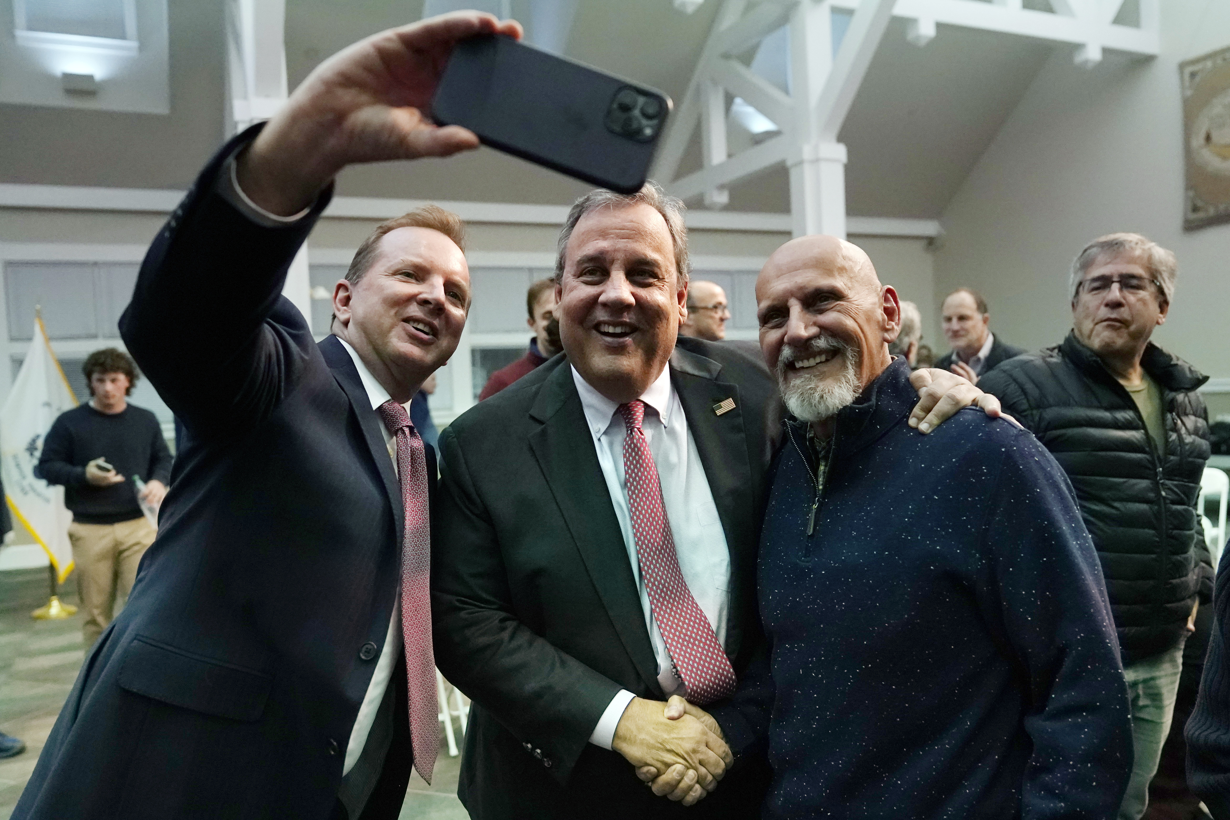 Former New Jersey Gov. Chris Christie, center, poses for a selfie after a town hall style meeting at New England College, April 20 in Henniker, N.H. Christie is set to launch his campaign for the White House at a town hall in New Hampshire Tuesday.