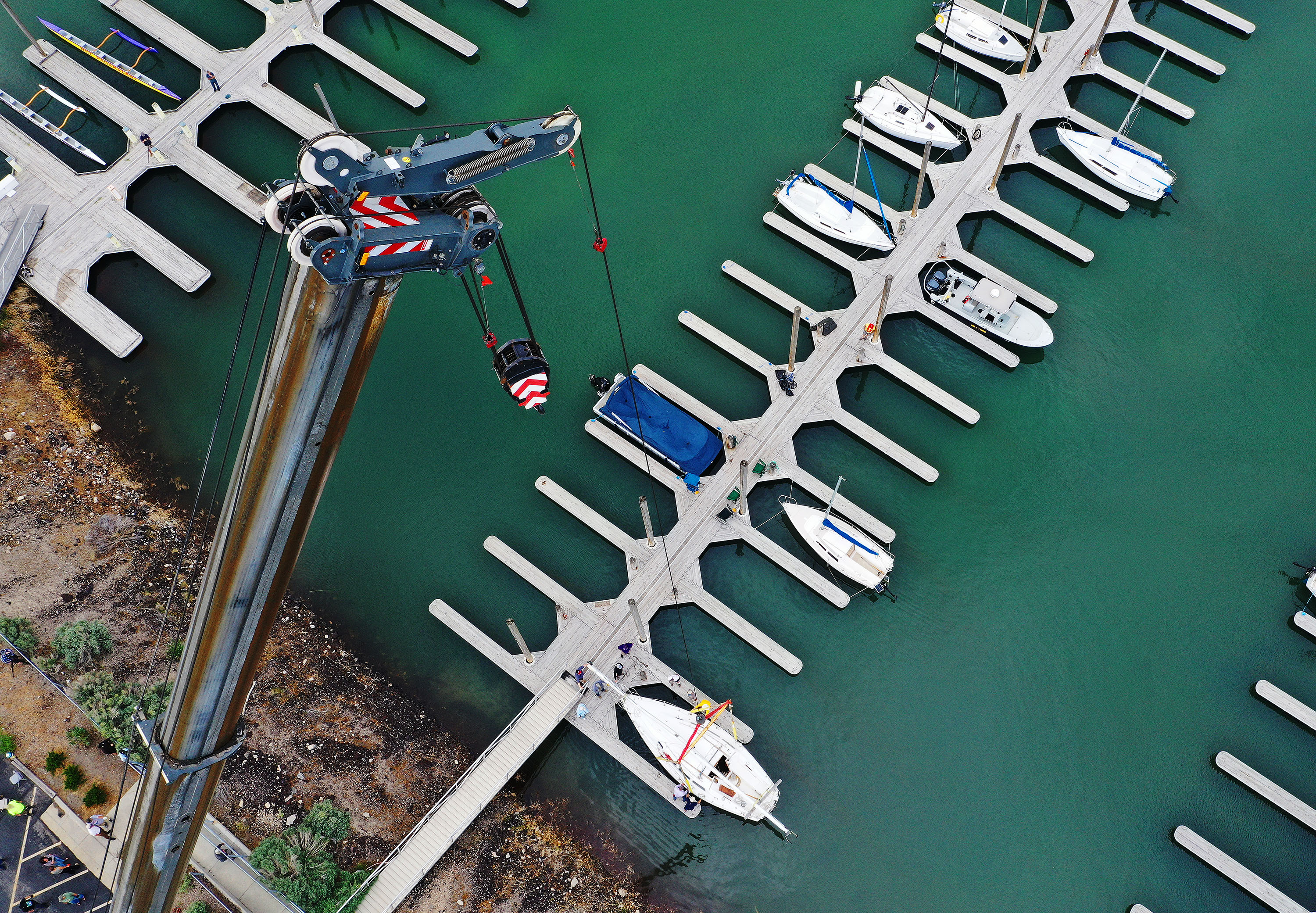 Sailboats are hoisted back into the Great Salt Lake marina in Salt Lake City on Tuesday. Water levels have raised enough for sailing on the lake.