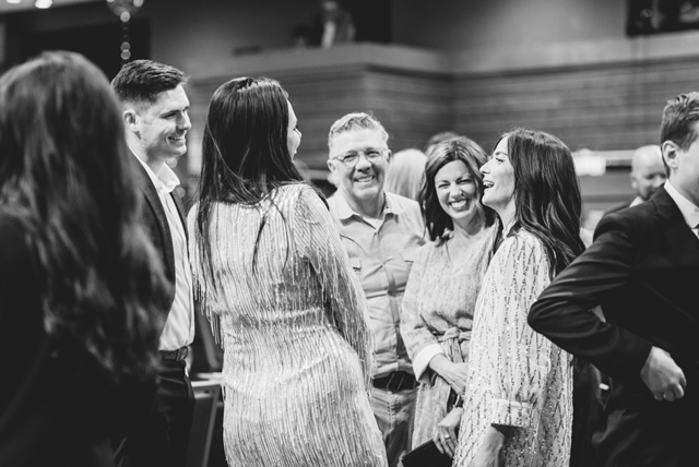 Group of attendees speak to Chief Experience Officer Jen Brockbank.