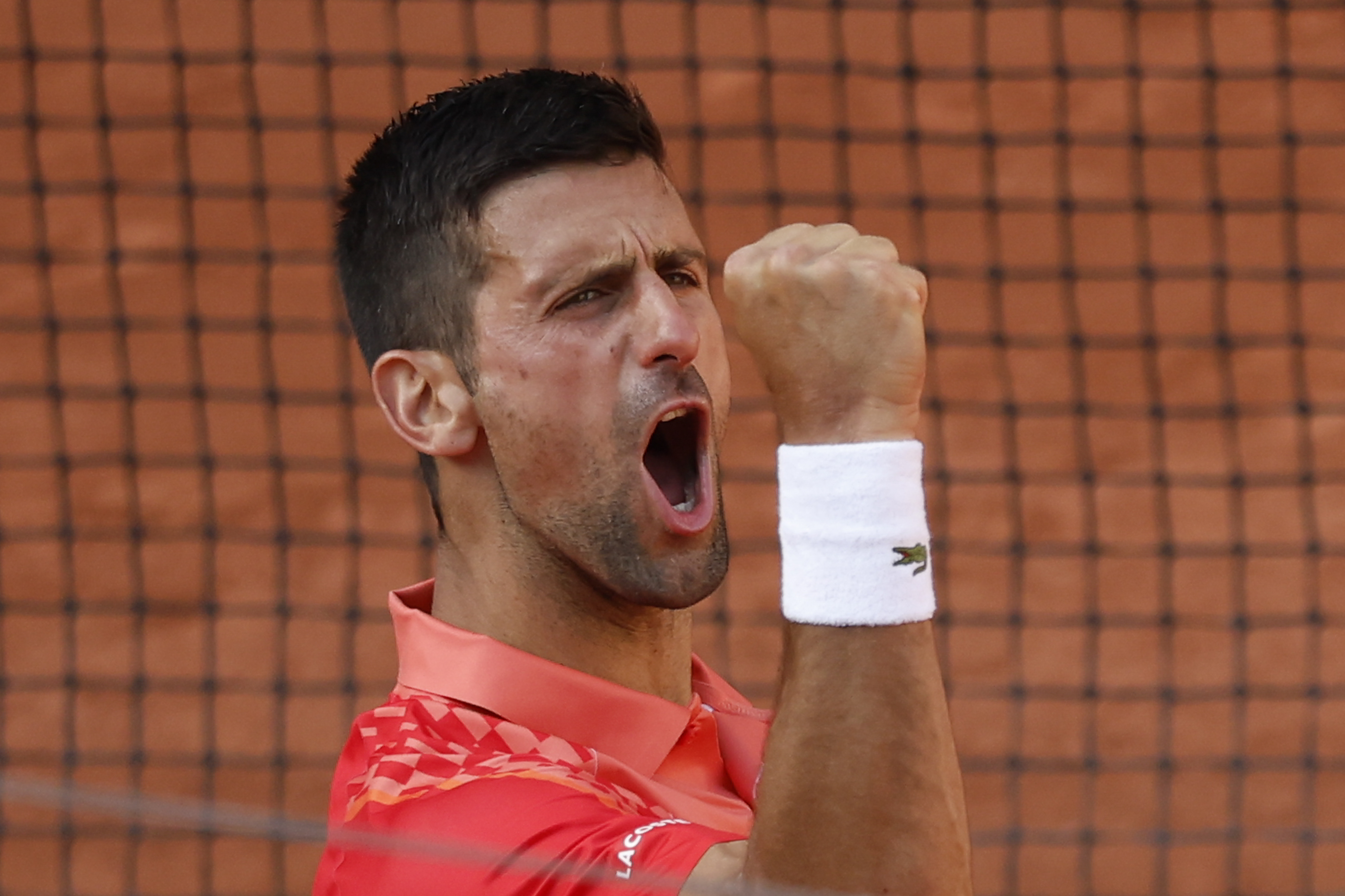 Serbia's Novak Djokovic celebrates winning his quarterfinal match of the French Open tennis tournament against Russia's Karen Khachanov in four sets, 4-6, 7-6 (7-0), 6-2, 6-4, at the Roland Garros stadium in Paris, Tuesday, June 6, 2023.