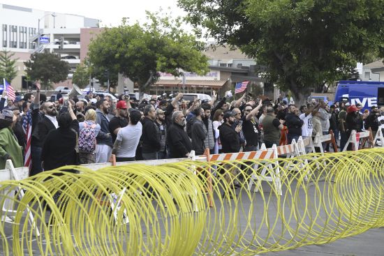 Conservative groups and LGBTQ+ rights supporters protest outside the Glendale Unified School District offices in Glendale, Calif., Tuesday.
