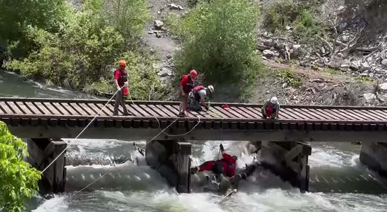 Crews work to clear debris, including a large log, from the Provo River Tuesday. Some people are ignoring warning signs and recreating in dangerous, closed areas of Provo Canyon, officials say.