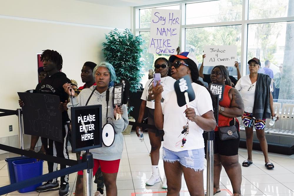 Protesters gather in the lobby of the Marion County Courthouse, Tuesday in Ocala, demanding the arrest of a woman who shot and killed Ajike Owens, a 35-year-old mother of four, last Friday night, June 2.