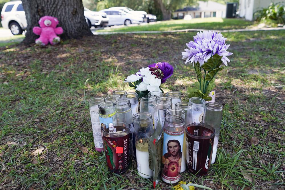 A small memorial is seen outside an apartment, Tuesday, in Ocala, Fla., where Ajike Owens, a 35-year-old mother of four was killed in a Friday night, June 2, shooting that Marion County Sheriff Billy Woods said was the culmination of a 2½-year feud between neighbors.
