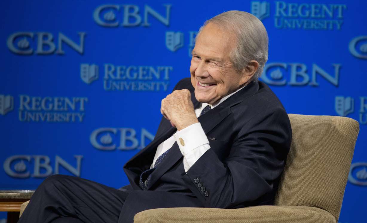 Rev. Pat Robertson listens as Republican presidential candidate Donald Trump speaks at Regent University in Virginia Beach, Va., Feb. 24, 2016. Robertson has died. He was 93.