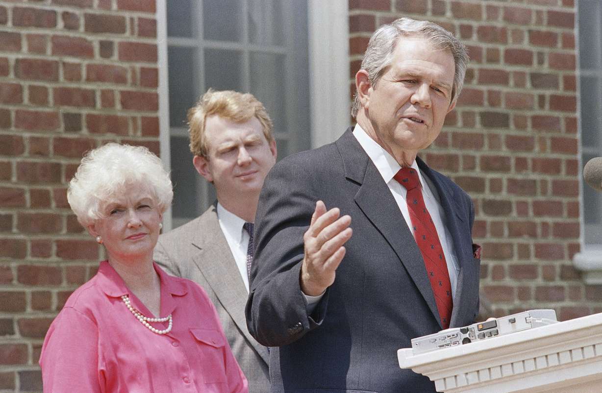 Former Republican presidential contender Pat Robertson announces that he is suspending his campaign, May 16, 1988, at his home in Virginia Beach, Va. Listening to Robertson are his son Tim and wife Dede. Robertson, a religious broadcaster who turned a tiny Virginia station into the global Christian Broadcasting Network, tried a run for president and helped make religion central to Republican Party politics in America through his Christian Coalition, has died.