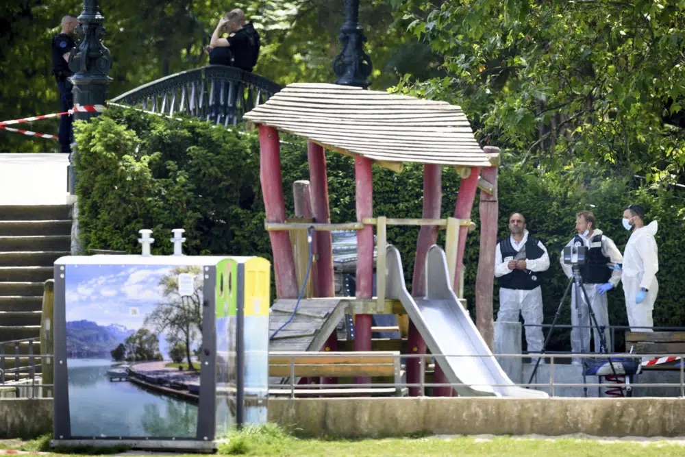 Security forces gather in a playground at the scene of knife attack in Annecy, French Alps, Thursday. An attacker with a knife stabbed several young children and at least one adult, leaving some with life-threatening injuries, in a town in the Alps on Thursday before he was arrested, authorities said.