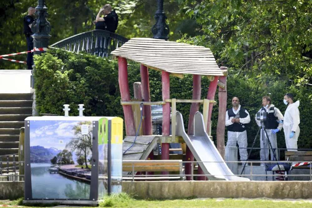 Security forces gather in a playground at the scene of knife attack in Annecy, French Alps, Thursday. An attacker with a knife stabbed several young children and at least one adult, leaving some with life-threatening injuries, in a town in the Alps on Thursday before he was arrested, authorities said.