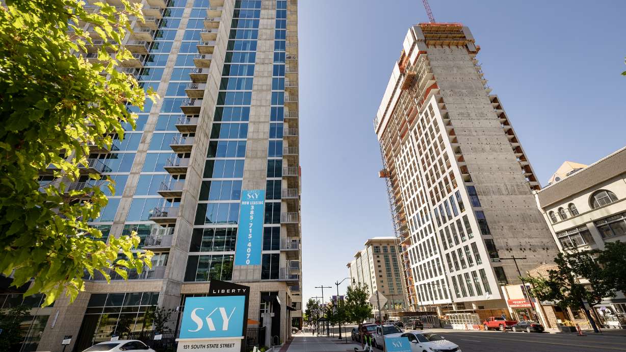 The Liberty Sky Apartments sit across from the Astra Tower luxury apartment building under construction in Salt Lake City on May 30. Kem C. The state's diverse economy could help Utahns in the event of a mild recession.