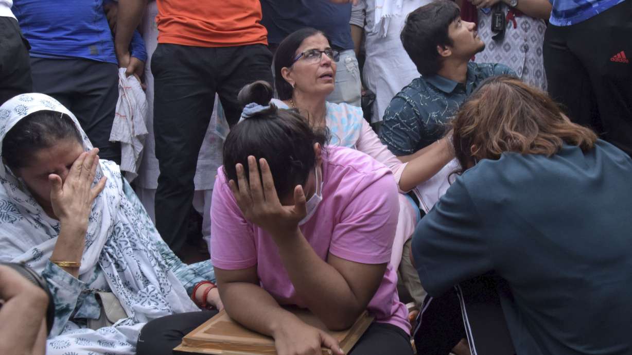 Sakshi Malik, an Indian wrestler who won a bronze medal at the 2016 Summer Olympics, sits with fellow wrestlers by the banks of the river Ganges in Haridwar, India, Tuesday, May 30, 2023. India's top wrestlers held off from throwing their medals into the country's sacred Ganges River on Tuesday as part of an ongoing protest against sexual harassment after community leaders intervened and persuaded them against doing so. They accuse Brij Bhushan Sharan Singh, the president of the Wrestling Federation of India, of sexually harassing seven young female wrestlers, including a minor.