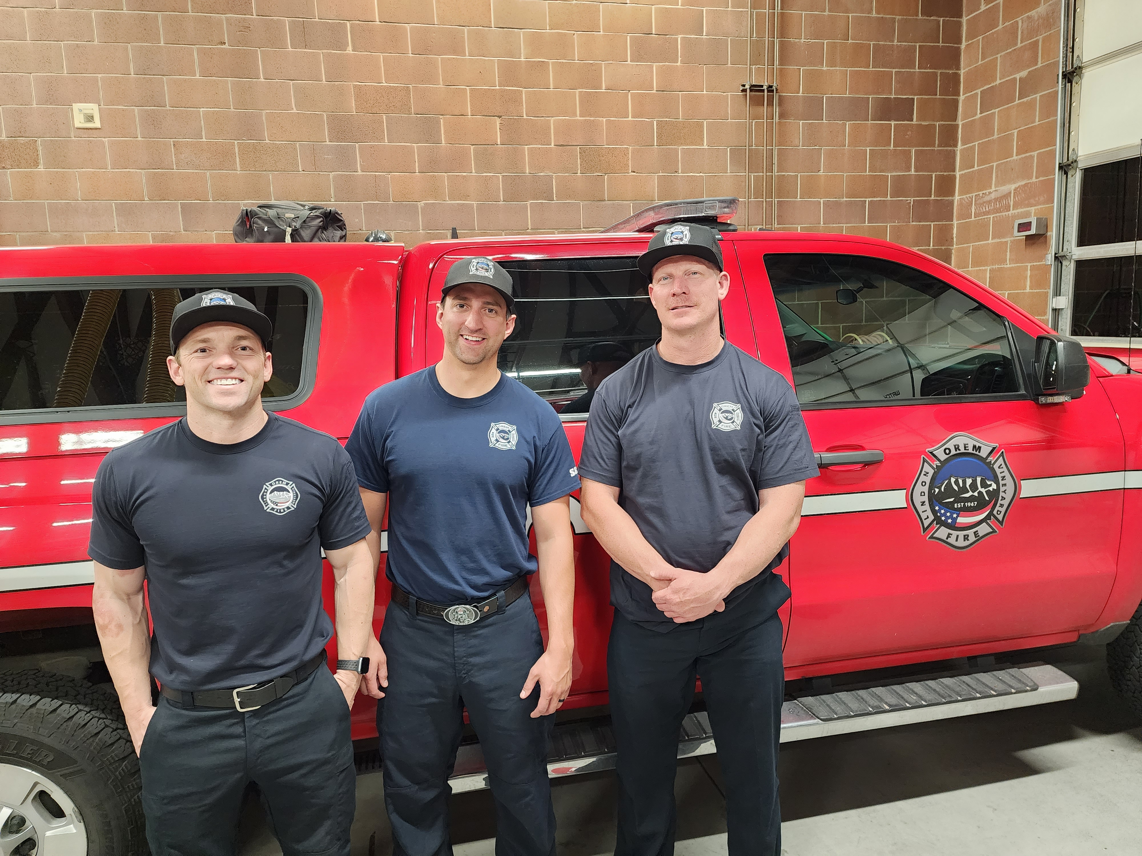 Critical care paramedics Tim Hope and Mike Hickman stand with Capt. Cameron Monahan of the Orem Fire Department Station 33. Behind them is the Squad vehicle that transports critical care paramedics.