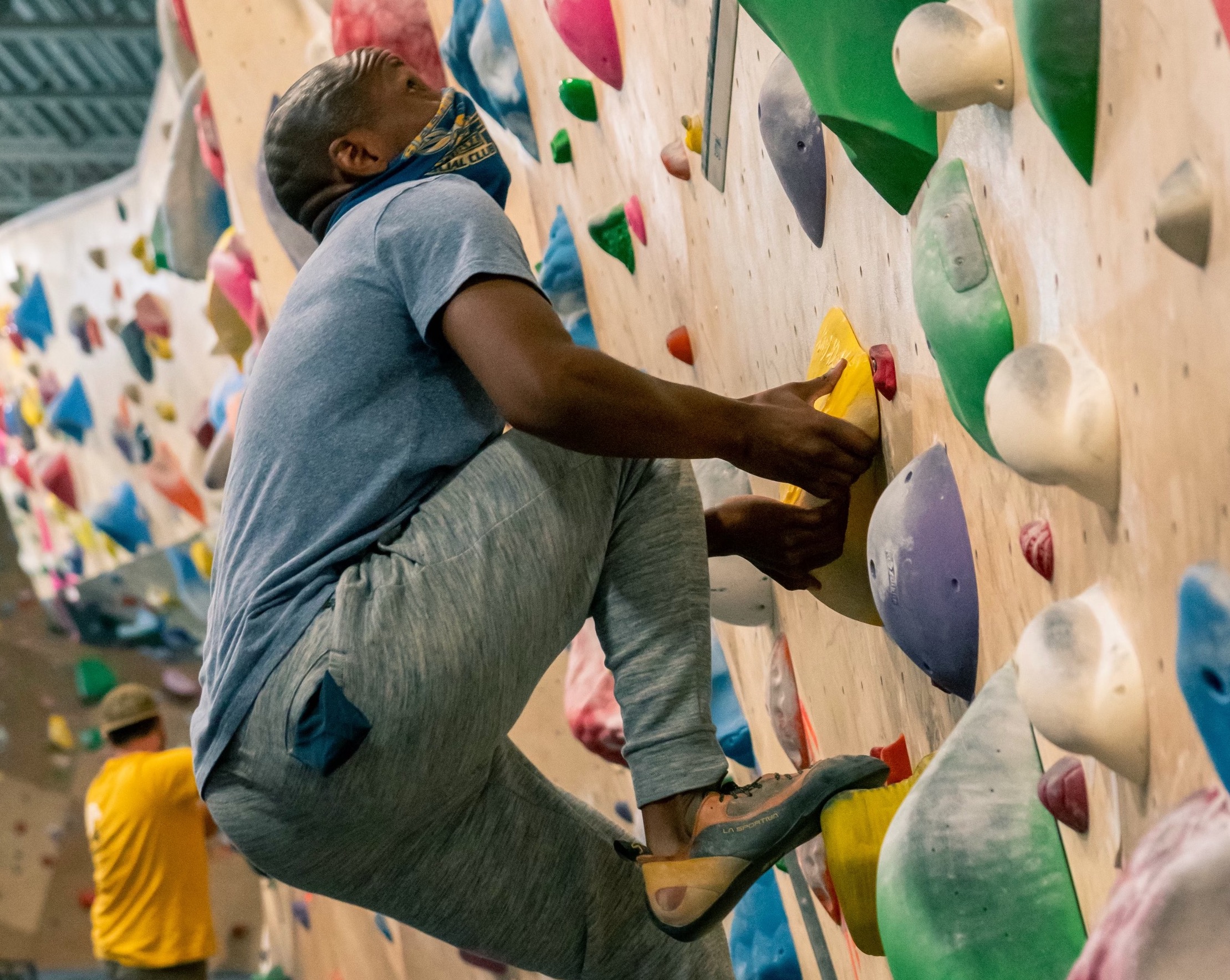 Isaac Fairley climbs in an indoor rock climbing gym. Several Utah advocacy groups are coming together to show Utahns who are part of minority groups in the state can engage with outdoor sports, public lands and environmental activism.