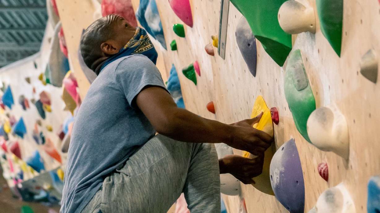 Isaac Fairley climbs in an indoor rock climbing gym. Several Utah advocacy groups are coming together to show Utahns who are part of minority groups in the state can engage with outdoor sports, public lands and environmental activism.