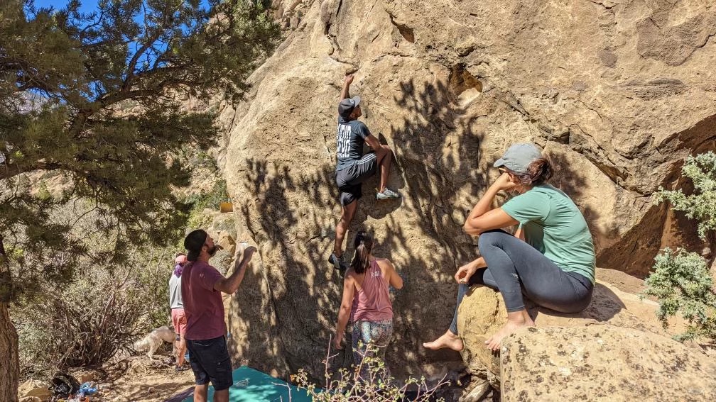 Isaac Fairley, top center, boulders with a group of friends.